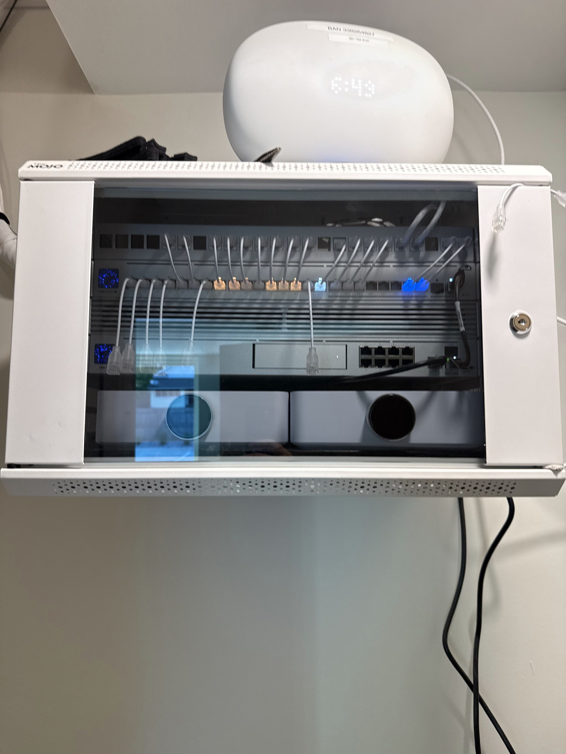 A clean UniFi network rack with a switch, patch panel, and access point, professionally installed by Sundae Software Solutions